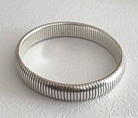 Side view of ribbed sterling silver stretch bangle