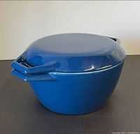 Side view of blue enamel Dutch oven with lid on