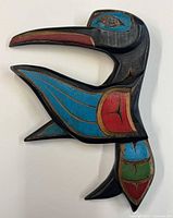 Front view showing carved hummingbird design and paint colors