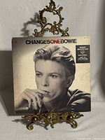 Front cover of ChangesOneBowie sleeve featuring Bowie portrait