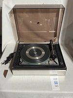 Full view of Dual 1216 turntable with dust cover closed and power cord visible