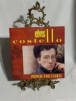 Front sleeve of Punch the Clock LP on stand