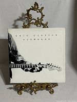 Front cover of Eric Clapton Slowhand LP on display stand