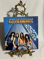 Front cover of Killer Dwarfs Stand Tall LP on stand