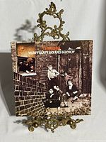 Front sleeve of The Who Meaty Beaty Big & Bouncy LP on display stand