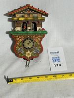 Front view of full clock with measuring tape for scale