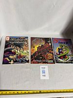 Group shot of three Champions RPG supplements showing covers and lot measuring tape