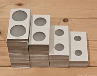 Four vertical stacks of cardboard coin flips showing window size variations