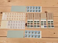 Stamp panes laid out: Maple Leaf panes, Parliament panes, blue commemoratives