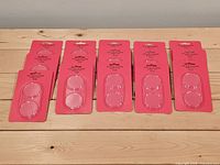 Seven retail cards each containing two clear acrylic coin holders