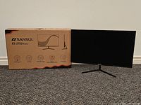 Monitor on stand alongside original box