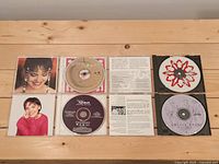 Open jewel cases showing discs and booklets for all four titles