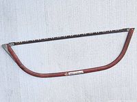 Full view of bow saw hanging horizontally