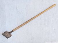 Full view of edger laid flat showing entire length and blade shape