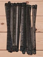 Stack of vintage hacksaw blades showing oxidation and double-hole ends