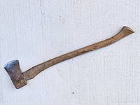 Full view of axe laid flat showing entire handle and head profile