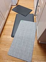 All three mats on floor showing relative sizes and colours