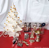 Full lot showing ceramic tree, cord, packaged figurine ornaments, assorted ornaments and decor pieces