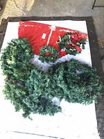 Lot overview showing garlands, two wreaths and red tree skirt