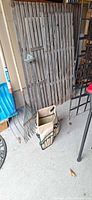 Overall lot showing trellis panel, rakes, shovel and organizer bag