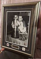 Full view of framed autographed photograph and frame