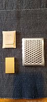 All three items: gold lighter, silver case, leather pouch