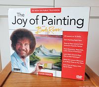 Front of box set showing title, Bob Ross image, painting, DVD logo