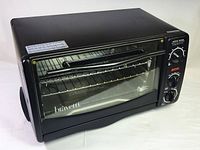 Front angled view of black Bravetti toaster oven with glass door closed