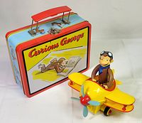 Toy biplane and lunchbox together
