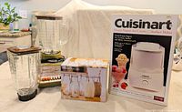 Group shot showing Cuisinart box, Osterizer blender with jar, spare jar, boxed glass cup set