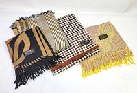 All four scarves laid out to show patterns and labels