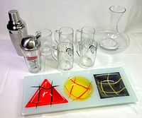 Group shot of all items: shakers, mugs, decanter, serving tray