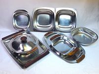 Group view showing all stainless and chrome serveware pieces with rosewood handles