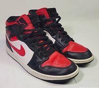 Oblique front view of both sneakers showing uppers, laces and toe boxes