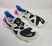 Top angled view of both shoes showing uppers, laces and swooshes