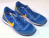 Left side view of both shoes showing colorway, uppers, swoosh, midsoles