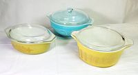 Three Pyrex pieces with lids displayed together