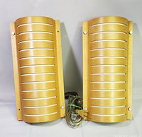 Front view of both sconces showing wood veneer slatted panels