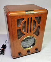 Front angled view of Thomas 711TH radio showing wood cabinet, power cord and knobs