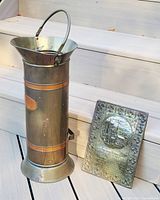 Coal scuttle and brass plaque together to show scale and set contents