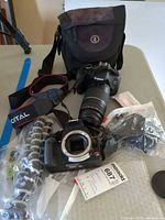 Overview of both camera bodies, zoom lens, tripod, bag, strap, caps