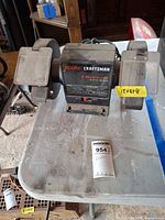 Front view of Craftsman 6" bench grinder on table