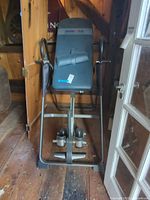 Full front view of Ironman inversion table within barn space