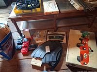 Group shot showing boxed Strombecker set, yellow Revell tray, Atlas curved tracks, red controllers and RC transmitter