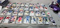 Overview of table covered with numerous stacks of hockey trading cards