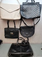 Group shot of all five handbags hanging