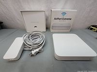 Router, power supply brick, AC cable and box laid out