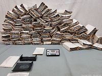 Stack of boxed alarm clocks with one unit and accessories displayed front