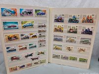 First image shows two album pages with automobile and motorcycle stamps