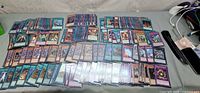 overall view of multiple stacks of Yu-Gi-Oh! cards laid out